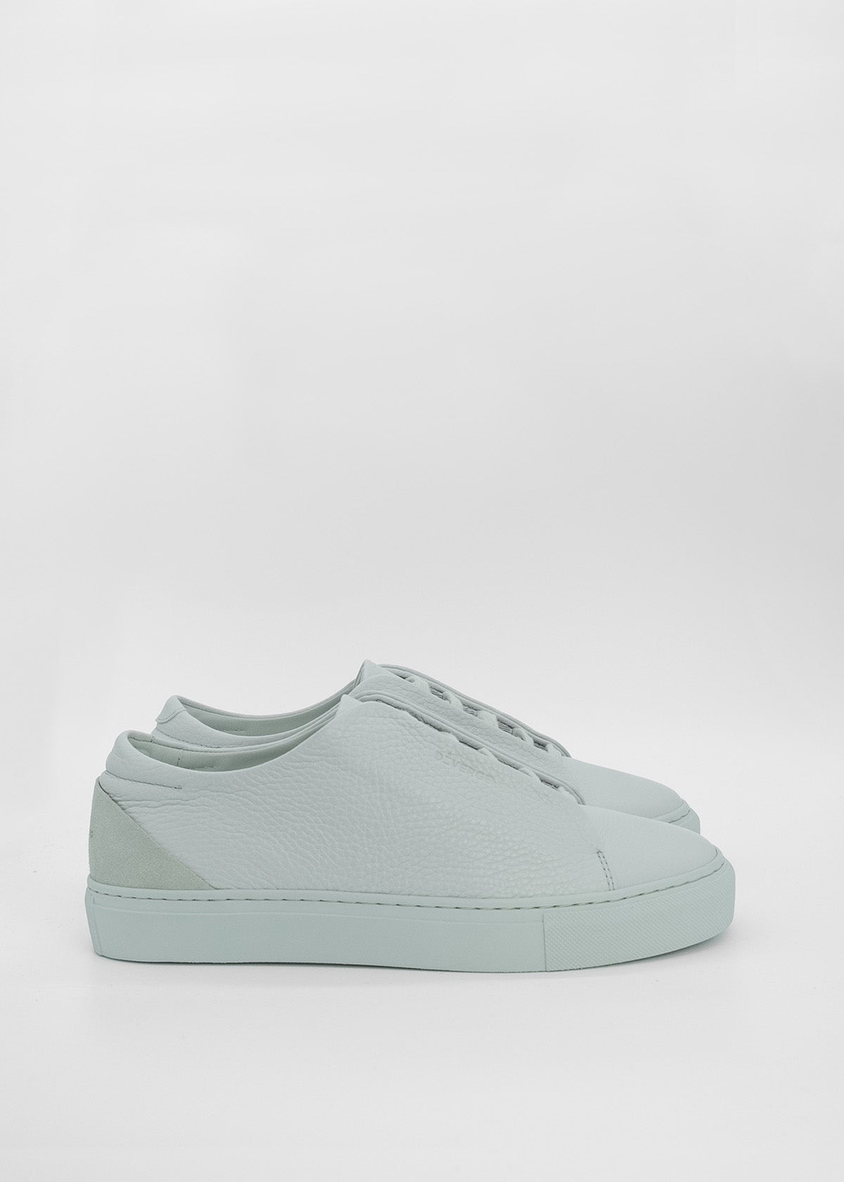 A pair of ML0033 Grey Floater, handcrafted in Portugal, with white soles on a white background.