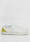 A pair of ML0085 White W/ Yellow with a distinct yellow accent on the heel, subtle branding stitched on the side, and ethically made to order from premium Italian leathers. Handcrafted in Portugal for unparalleled quality.