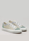 A pair of V9 Antique-White & Lilac low-top canvas shoes with green and blue accents on a plain background.