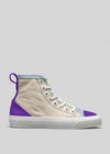 A TH0009 by Sofia with beige canvas, white laces, a purple heel, and a thick white rubber sole, displayed against a neutral background.