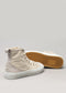 A pair of high-top V4 Antique White Canvas sneakers, with one standing upright and the other lying on its side, showcasing the textured gum sole.