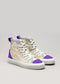 A pair of TH0009 by Sofia with cream canvas, purple accents, and multicolored laces on a grey background.
