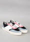 A pair of stylish N0003 by Márcia sneakers with pink, white, and blue panels on a gray background.