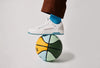 A custom shoe on top of a coloured ball.