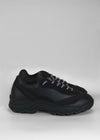 A pair of L0011 Black Leather low top sneakers with thick soles on a plain white background.