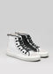 A pair of TH0004 by Martim high-top canvas shoes with a white canvas and black laces on a gray background.