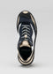 A single L0005 by Tiago low top sneaker viewed from above on a neutral background.