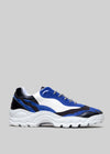 A side view of a blue and white L0004 by Daniel with black accents and a chunky, waved white sole.