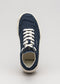 A single V8 Full Color Marine Blue canvas sneaker with white laces and a white rubber sole, viewed from above on a light grey background.