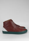 A pair of MH0028 Red Wine w/ Forest Green sneakers featuring a two-tone design with red leather uppers and green rubber soles, perfect as custom shoes.