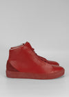 A pair of MH0053 Red w/ Scarlet high-top sneakers on a grey background.