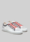 A pair of TL0001 by Nuno with red laces on a light gray background.