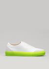 White slip-on sneaker with a SO0001 JL Fluo-Corra sole on a gray background.