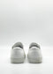 The ML0115 White Leather sneakers, meticulously handcrafted in Portugal from premium Italian leathers, are elegantly showcased from the back against a plain background.