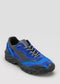 A blue and black handcrafted sneaker, L0015 by Iara, with a patterned design, featuring a black sole and laces, displayed against a plain grey background.