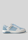 The M0008 by Pinto is a low-top retro-future sneaker with a white and light blue color scheme, featuring a white sole, blue laces, and a mix of premium Italian leathers and suede materials. Handcrafted in Portugal for unparalleled quality.