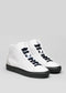 A pair of MH0113 by Braima with black soles and black laces, crafted from premium Italian leathers and set against a plain gray background.