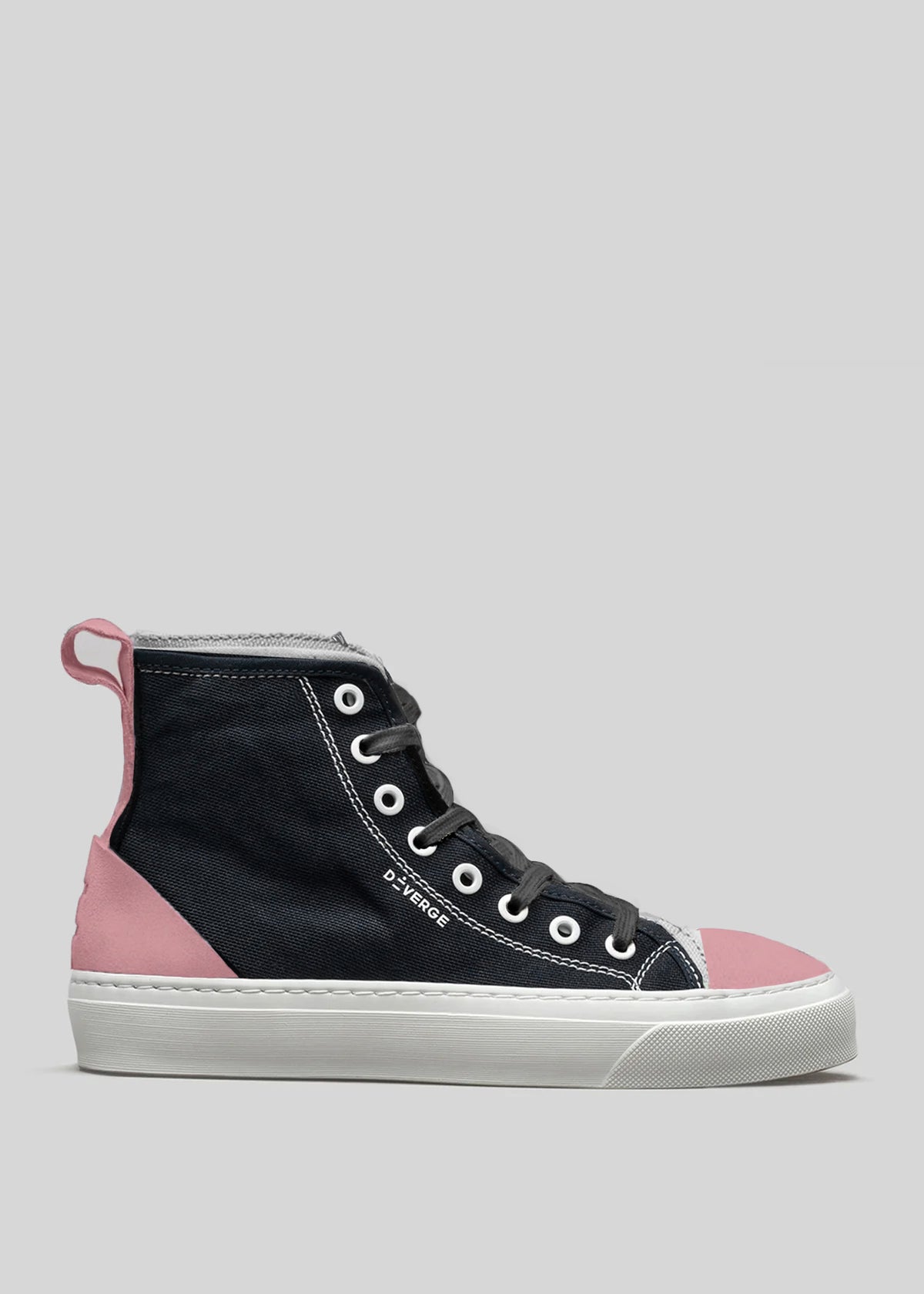 The TH0016 by Ude features a black premium canvas upper and soft suede accents, pink details on the toe cap, heel, and rear pull tab, grey laces, white midsole, all set against a grey background. Handcrafted in Portugal for exceptional quality.