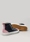 A pair of TH0016 by Ude crafted from premium canvas and soft suede, featuring a navy blue upper, pink heel, and white rubber sole. One shoe is upright while the other rests on its side revealing the tan outsole. Handcrafted in Portugal for superior quality.