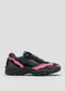 The L0015 by Becas, a black athletic shoe with pink accents, a chunky sole, and black laces, is displayed against a plain background, impeccably crafted from premium Italian leathers.