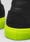 Close-up of V51 Black W/ Yellow high-top sneakers showcasing neon yellow soles and a textured black heel crafted from premium Italian leathers.