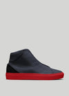 The V49 Deep Blue W/ Red, a handcrafted high-top sneaker from Portugal, showcases a textured leather finish and a bright red rubber sole against a plain gray background.