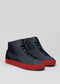 The V49 Deep Blue W/ Red is a pair of dark high-top sneakers handcrafted in Portugal with premium Italian leathers, featuring striking red soles on a light gray background.