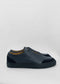 Une paire de SO0015 Deep Blue Floater slip-on sneakers avec une épaisse semelle noire, présentée sur un fond gris clair.