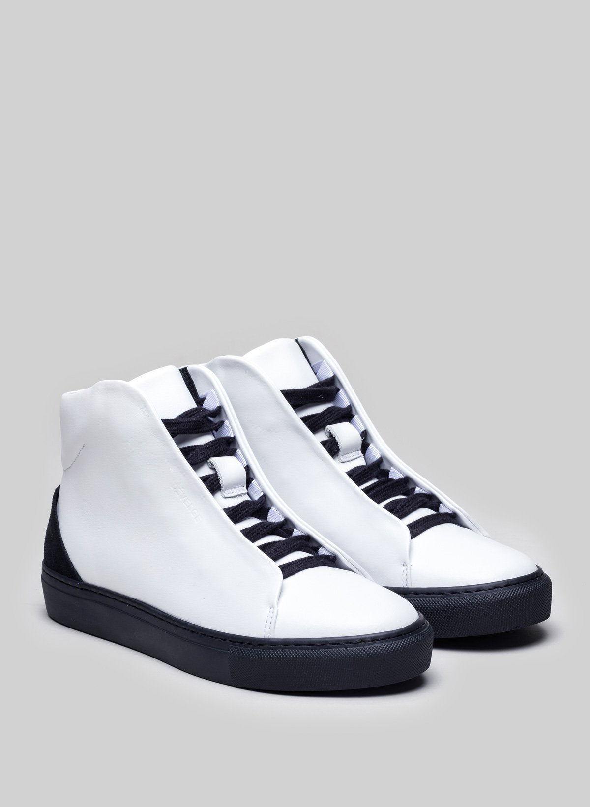White high top sneakers with black soles and laces, custom shoes by Diverge.