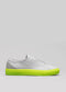 The V50 Grey W/ Yellow sneaker, handcrafted in Portugal from premium Italian leathers, features a textured surface and bold neon yellow sole. Shown from the side on a gray background, it exemplifies an exquisite blend of elegance and style.