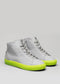 The V50 Grey W/ Yellow high-top sneakers, featuring bright yellow-green soles and handcrafted in Portugal, are displayed against a plain background.