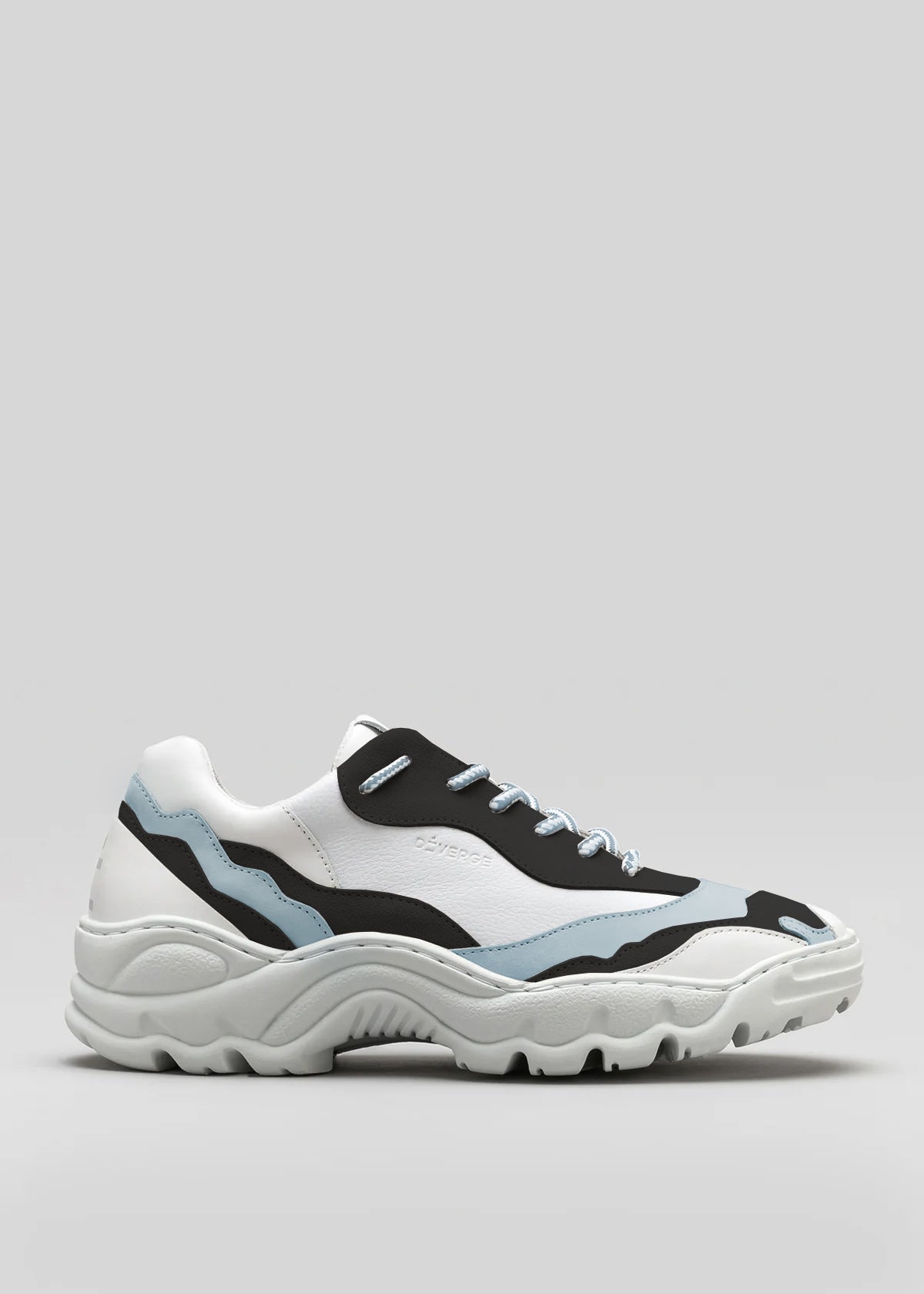 The L0020 by Lara is a premium handcrafted chunky white sneaker with black and light blue accents, featuring a thick sole and blue laces, crafted from exquisite Italian leathers, set against a plain gray background.