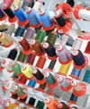 Assorted spools of thread for shoe maker creating custom sneakers with a focus on responsible production.