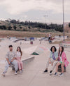A group of people sitting on a skateboard ramp, wearing Diverge sneakers, promoting social impact and custom shoes, throught the imagine project.