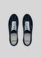 A pair of V3 Marine sneakers, handcrafted in Portugal with navy canvas, white laces, and rubber cupsoles, viewed from above on a gray background.