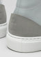The V55 Light Grey W/ Bone showcases a handcrafted sneaker heel with a light gray suede overlay and white midsole. A subtle embossed design on the heel enhances its premium feel.