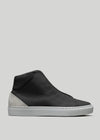 The V56 Black W/ Bone high-top sneaker, handcrafted in Portugal, boasts a smooth leather upper and gray suede heel accent. Made with premium Italian leathers and set on a white rubber sole, it's displayed on a light gray background.