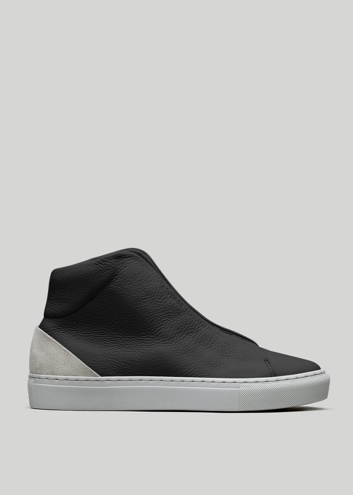 The V56 Black W/ Bone high-top sneaker, handcrafted in Portugal, boasts a smooth leather upper and gray suede heel accent. Made with premium Italian leathers and set on a white rubber sole, it's displayed on a light gray background.