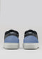 Rear view of V56 Deep Blue W/ Lake sneakers in black with blue heels and white soles on a gray background, handcrafted in Portugal using premium Italian leathers.
