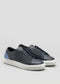 The V56 Deep Blue W/ Lake sneakers feature black leather with a white sole and blue heel accent, handcrafted in Portugal from premium Italian leathers, set against a plain gray background.