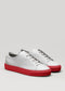 sneakers in pelle premium grigia e rossa in un design pulito vista frontale