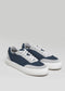 A pair of V30 Plaster & Deep Blue sneakers with white soles and laces on a plain gray background.