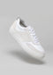 Introducing the V31 White & Plaster sneaker: handcrafted in Portugal with premium Italian leathers, featuring a lace-up design and suede accents on a gray background.