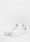 A pair of N0010 Vegan White & Grey sneakers with blue accents on a plain white background.