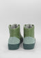 A pair of MH0082 Green leather ankle boots viewed from the back, showing thick rubber soles with circular logos.