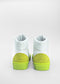 MH0060 White W/ Lime sneakers, seen from behind on a light gray background, feature green suede heels and soles. Handcrafted with premium Italian leathers, these stylish shoes blend elegance with sustainable and ethical craftsmanship.