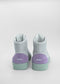 A pair of MH0068 Grey W/ Lilac high-top sneakers with white uppers, purple heel caps, and green soles, viewed from the back against a white background.