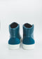 Une paire de MH0066 Ocean Blue W/ White high-top sneakers avec des semelles blanches, vue de dos sur un fond blanc uni.