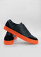 A pair of SO0016 Black W/ Orange slip-on shoes on a white background.