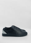 A pair of ML0037 Black W/ Grey with a textured upper crafted from premium Italian leathers and smooth black rubber soles against a plain white background.